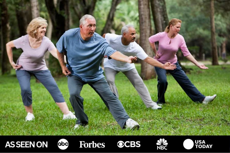 A group of older adults practicing Tai Chi together in a park — as seen on ABC, Forbes, CBS, NBC and USA Today